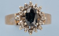 Lot 774 - A sapphire and diamond cluster ring, the oval...