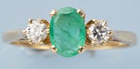 Lot 776 - An emerald and diamond ring, the oval facet...