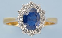 Lot 780 - A sapphire and diamond cluster ring, the oval...