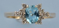 Lot 782 - A topaz and diamond ring, the oval facet cut...