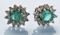 Lot 796 - A pair of emerald and diamond cluster earrings,...