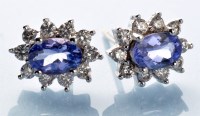 Lot 799 - A pair of tanzanite and diamond cluster...