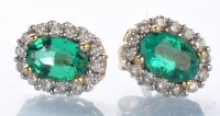 Lot 801 - A pair of emerald and diamond cluster stud...