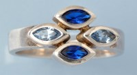 Lot 809 - A sapphire dress ring, set with two tones of...