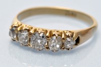 Lot 811 - A five stone diamond ring, graduated old...