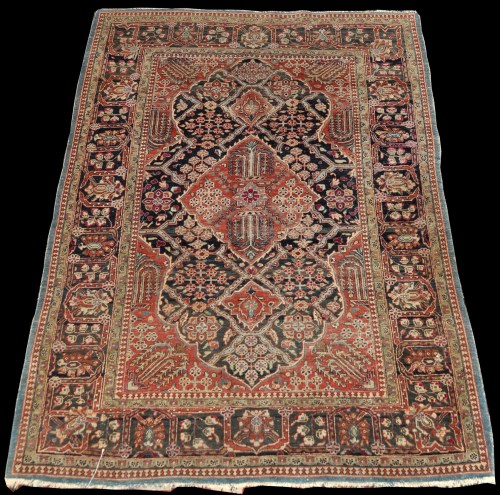 Lot 818 - A Kinuan rug, the shaped field with floral...