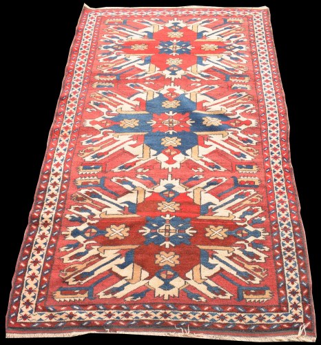 Lot 826 - A Caucasian rug, with bold triple medallion on...