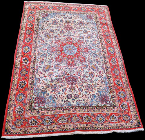 Lot 828 - A Isfahan rug, the red circular medallion...