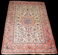 Lot 830 - An Isfahan rug, the central red medallion...