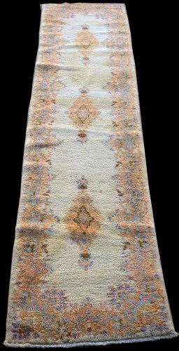 Lot 858 - A Kirman runner, with three floral medallions...