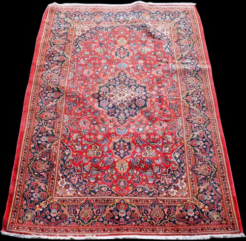 Lot 861 - A Kashan rug, with scrolling floral design...