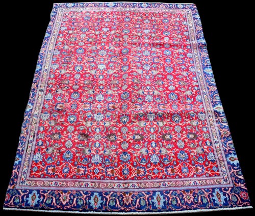 Lot 874 - A Najafabad rug, with foliate scrolls on red...