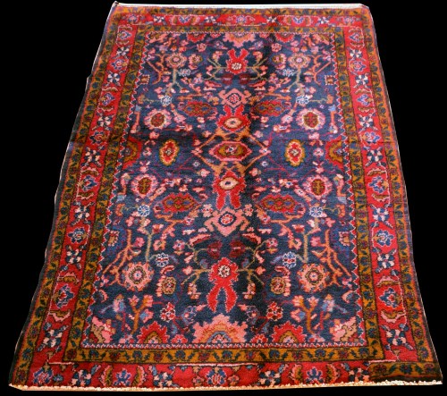 Lot 895 - A Mashad rug, with floral design on blue...