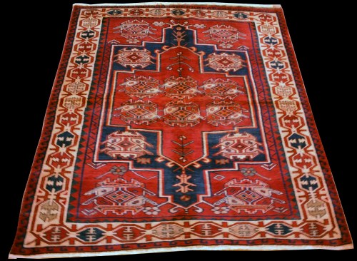 Lot 896 - A Shiraz rug, with geometric design on red...