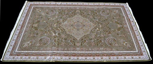 Lot 901 - A Persian woven silk carpet, with green ground...