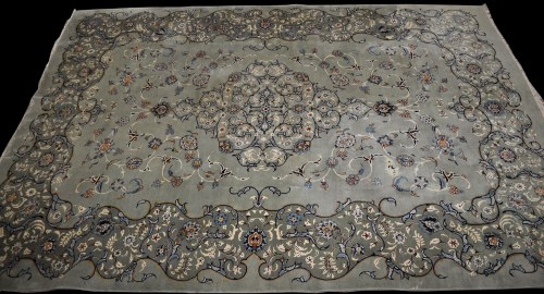 Lot 907 - A Kirman carpet, the green field with central...