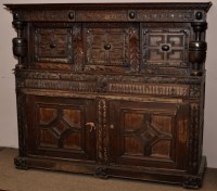 Lot 947 - A carved oak court cupboard, the upper section...