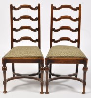 Lot 1027 - A pair of 18th Century oak ladder back chairs,...