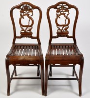 Lot 1045 - A pair of carved Chinese hardwood chairs, with...