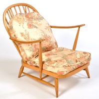 Lot 58 - A low beech wood armchair, probably by Ercol,...