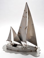 Lot 186 - A chromed metal model of a sailing ship at sea,...