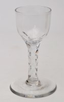 Lot 329 - Faceted wine glass, light ovoid bowl above...