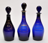 Lot 340 - Three blue glass decanters and stoppers, with...