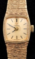 Lot 789 - Omega: a ladies 9ct. gold wristwatch, shaped...