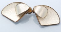 Lot 844 - A pair of white enamel silver ear clips, by...