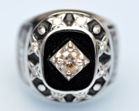 Lot 845 - A diamond, onyx, black enamel and white metal...