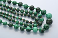 Lot 858 - A single row graduated malachite bead necklace,...