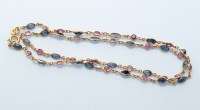 Lot 859 - A ruby and sapphire necklace, alternately set...