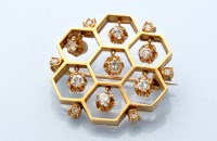 Lot 866 - A diamond set honeycomb pattern brooch, each...