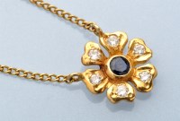 Lot 872 - A sapphire and diamond set flower pattern...