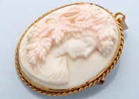 Lot 875 - A carved coral cameo, circa. 1900, depicting...