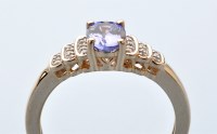 Lot 888 - A tanzanite and diamond ring, the oval facet...