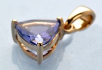 Lot 891 - A tanzanite pendant, the trilliant cut...