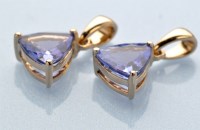 Lot 892 - A tanzanite pendant, the trilliant cut...