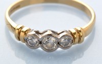 Lot 904 - A three stone diamond ring, the brilliant cut...