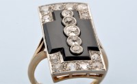 Lot 913 - An Art Deco onyx and diamond ring, set with a...