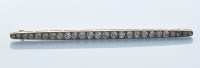 Lot 920 - An Edwardian diamond bar brooch, set with...