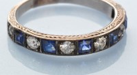 Lot 922 - A sapphire and diamond half hoop eternity ring,...