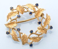 Lot 924 - An 18ct. yellow gold wreath brooch, set with...