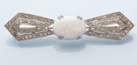 Lot 931 - A synthetic opal and diamond bow pattern...