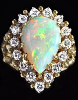 Lot 935 - An opal and diamond cluster ring, the...