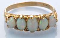 Lot 940 - A five stone opal ring, the oval graduated...