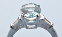 Lot 941 - An aquamarine and diamond ring, the oval facet...