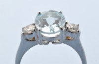 Lot 942 - An aquamarine and diamond ring, the oval facet...