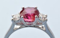 Lot 943 - A ruby and diamond ring, the circular facet...