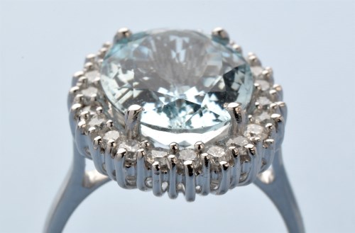 Lot 944 - An aquamarine and diamond cluster ring, the...
